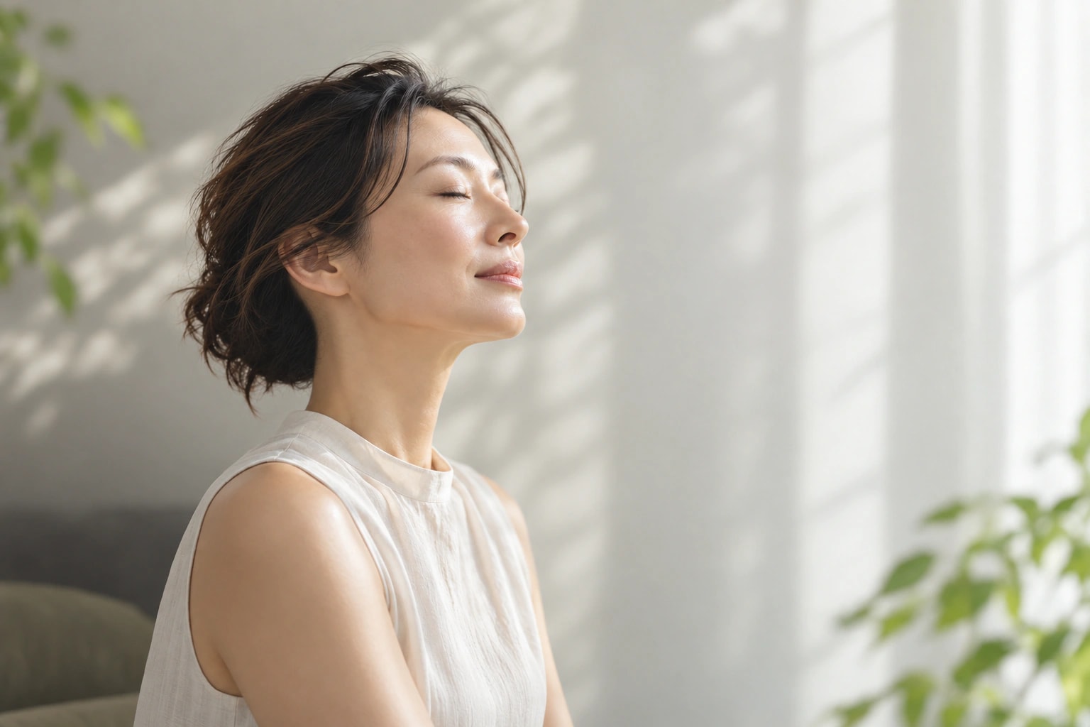 柔らかな光の中で目を閉じ、穏やかに過ごす女性